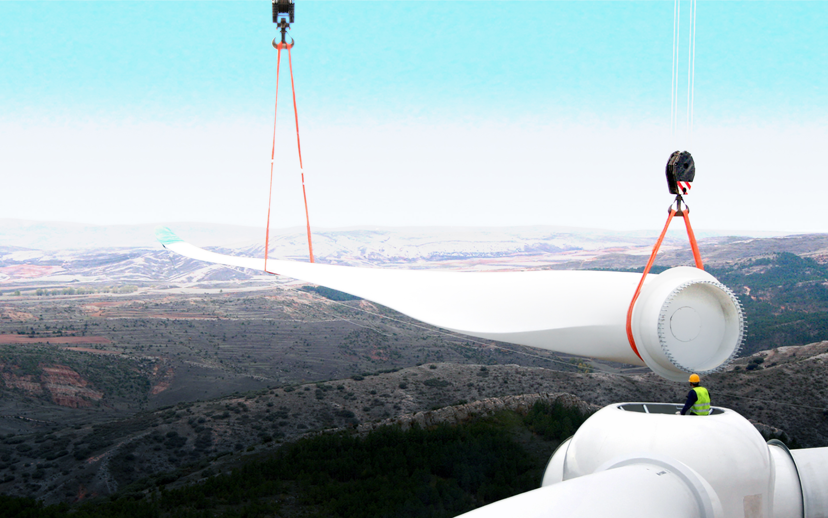 Wind turbines with engineer silhouette against sky
